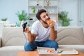 The man eating pizza having a takeaway at home relaxing resting Royalty Free Stock Photo