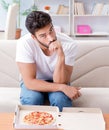 Man eating pizza having a takeaway at home relaxing resting Royalty Free Stock Photo