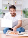 Man eating pizza having a takeaway at home relaxing resting Royalty Free Stock Photo