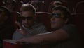 Man eating popcorn in 3d cinema. Spectactors enjoy cinema snacks