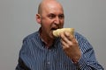 Man eating potato chips hurriedly Royalty Free Stock Photo