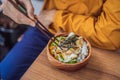 Man eating Raw Organic Poke Bowl with Rice and Veggies close-up on the table. Top view from above horizontal Royalty Free Stock Photo