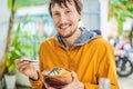 Man eating Raw Organic Poke Bowl with Rice and Veggies close-up on the table. Top view from above horizontal Royalty Free Stock Photo