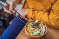 Man eating Raw Organic Poke Bowl with Rice and Veggies close-up on the table. Top view from above horizontal Royalty Free Stock Photo