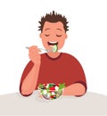 Man is eating a salad. Vegetarian. The concept of proper nutrition and healthy lifestyle