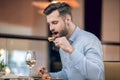 Man eating seafood at the restaurant and looking involved