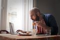 Man eating spaghetti and using computer Royalty Free Stock Photo