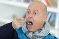 man eating spoon full medicine tablets and pills Royalty Free Stock Photo