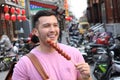 Man eating sugar-coated haws on a stick in China Royalty Free Stock Photo