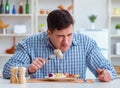 Man eating tasteless food at home for lunch Royalty Free Stock Photo