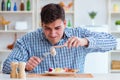 Man eating tasteless food at home for lunch Royalty Free Stock Photo