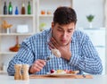 Man eating tasteless food at home for lunch Royalty Free Stock Photo