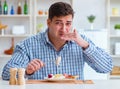 Man eating tasteless food at home for lunch Royalty Free Stock Photo