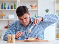 Man eating tasteless food at home for lunch Royalty Free Stock Photo