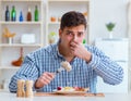 Man eating tasteless food at home for lunch Royalty Free Stock Photo