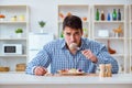 The man eating tasteless food at home for lunch Royalty Free Stock Photo