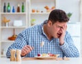 Man eating tasteless food at home for lunch Royalty Free Stock Photo