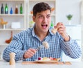 Man eating tasteless food at home for lunch Royalty Free Stock Photo