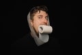 Man eating toilet paper. Hunger strike Royalty Free Stock Photo