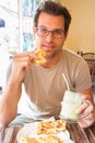 Man eating traditional moroccan breakfast in coffee shop.