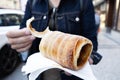 Man eating a typical Czech trdelnik in Prague