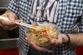 Man eats fried rice with chopsticks for sushi