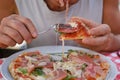 man eats Italian pizza, with salami, cheese, arugula, , male hands take pieces of pizza with salami, cheese, arugula, hands with Royalty Free Stock Photo