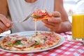 man eats Italian pizza, with salami, cheese, arugula, , male hands take pieces of pizza with salami, cheese, arugula, hands with Royalty Free Stock Photo