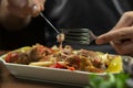 man eats lamb stew on the bone with vegetables. Khashlama is popular Armenian dish, which is prepared from beef with vegetables. Royalty Free Stock Photo