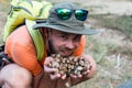 Man eats nuts isolated on a light background Royalty Free Stock Photo