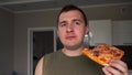 man eats pizza in front of the camera. 4k footage