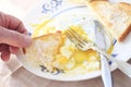 Man eats runny eggs and toast POV