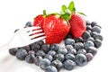 A man eats strawberries with a fork Royalty Free Stock Photo