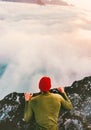 Man on the edge cliff above clouds gaze into abyss Royalty Free Stock Photo