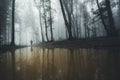 Man on edge of forest lake