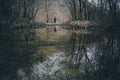 Man on edge of lake in forest in autumn Royalty Free Stock Photo