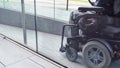 Man on electric wheelchair driving on a street. Accessibility concept