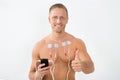 Man with electrodes showing thumbs up Royalty Free Stock Photo