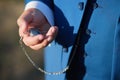 A man in elegant blue suit holding pocket watch with chain in his hand. Royalty Free Stock Photo