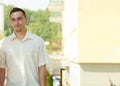 Man in elegant white summer shirt outside.