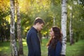 Man embraces girl on a walk in the autumn park