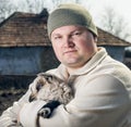 Man embracing a goatling. Royalty Free Stock Photo