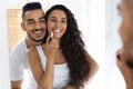 Man Embracing His Wife While She Applying Lipstick Near Mirror Royalty Free Stock Photo