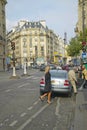 Man emerging from taxi on street, Paris, France