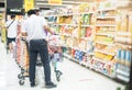 The man employer wear surgical mask arranging food at the supermarket aisle for prepare to shopper buy to hoarding food for the