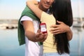 Man with engagement ring making proposal to his girlfriend near river, closeup Royalty Free Stock Photo