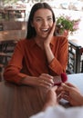 Man with engagement ring making proposal to his girlfriend in outdoor cafe Royalty Free Stock Photo