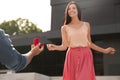 Man with engagement ring making proposal to his girlfriend outdoors, closeup Royalty Free Stock Photo