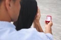 Man with engagement ring making proposal to his girlfriend outdoors, closeup Royalty Free Stock Photo