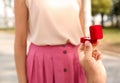 Man with engagement ring making proposal to his girlfriend in park, closeup Royalty Free Stock Photo